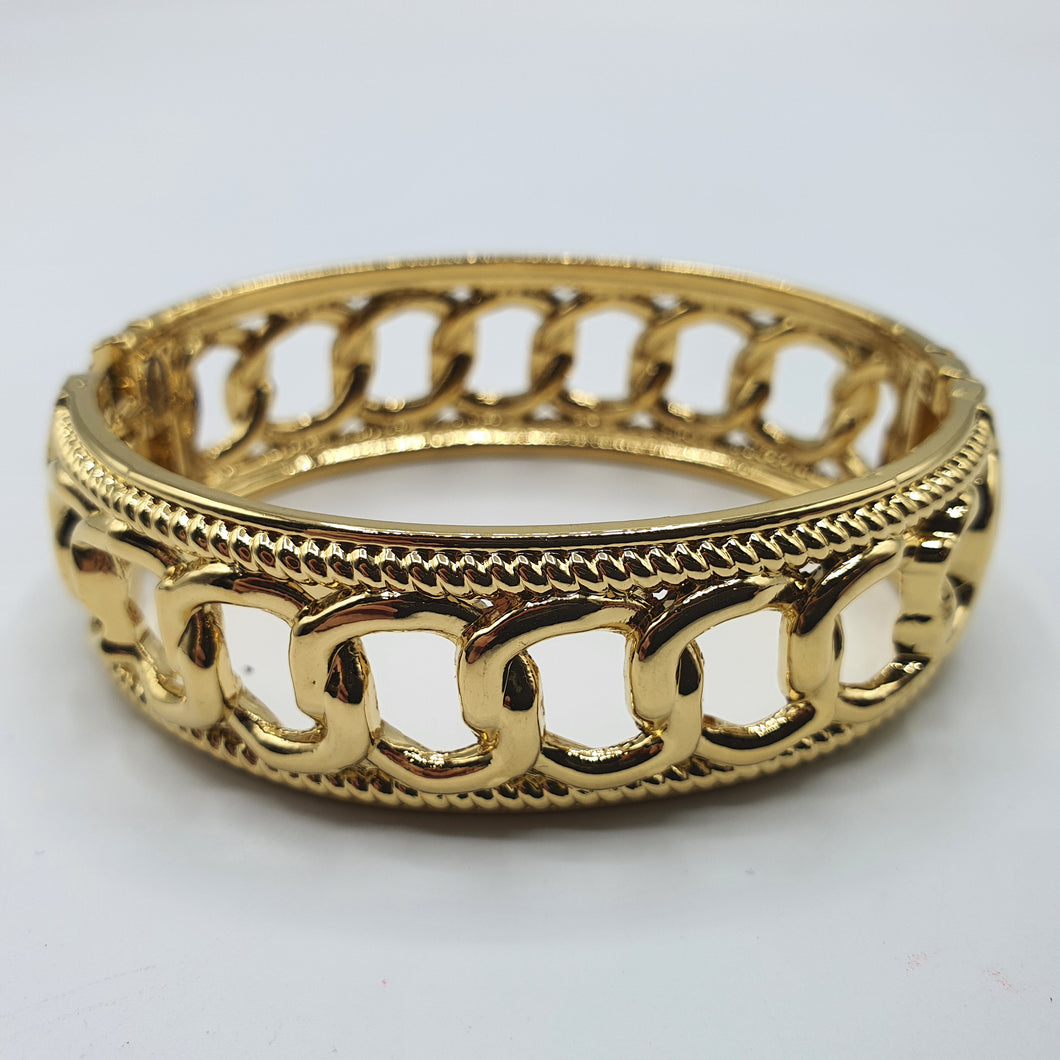 Bracciale rigido, modello  manetta,  in acciaio placcato oro.